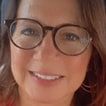 Yolanda Nash, smiling, in large glasses, a close-up selfie.